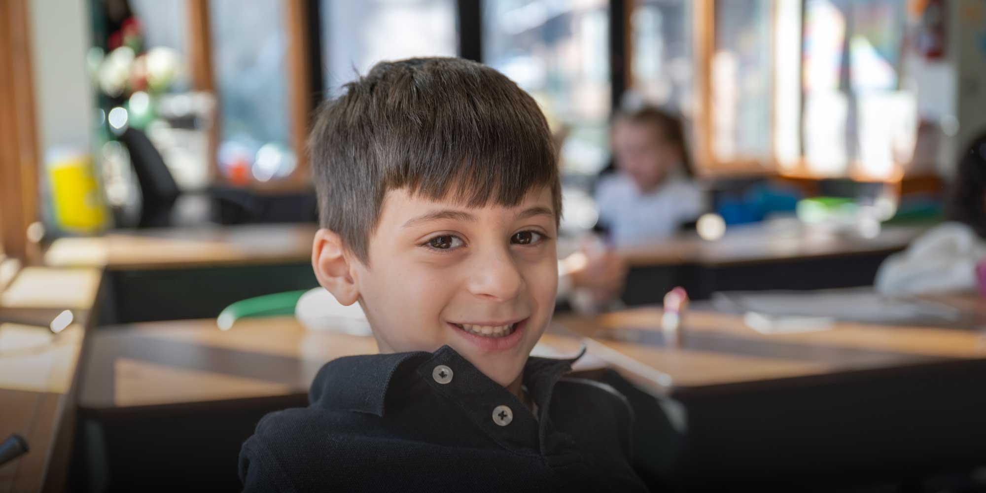 Smiling student sitting at desk